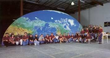 Super Vision employees in front of one half of the world's largest fiber optic display